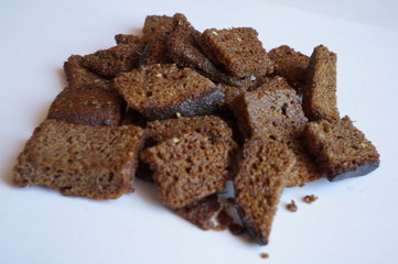 toasted garlic croutons from rye bread on white background