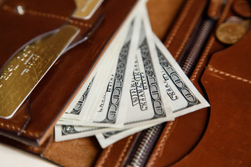 Dollars cash in a brown wallet