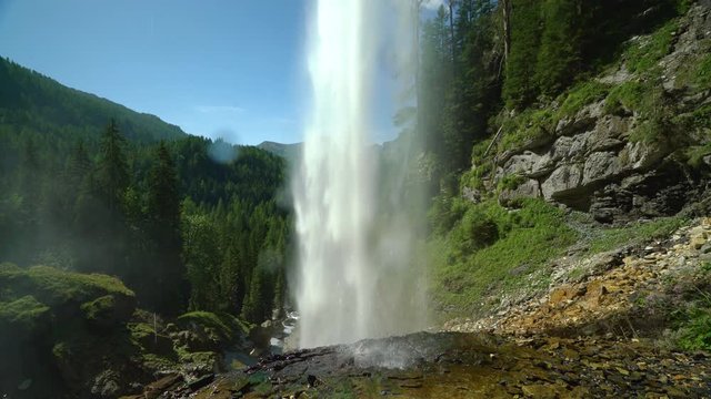 4k nature video behind waterfall on sunny summer day in mountains and forest loop with audio
