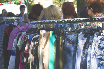 Fototapeta na wymiar clothes hanging on hangers. sale on the street