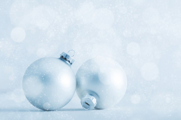 Christmas glass balls on cold frosty glitter background