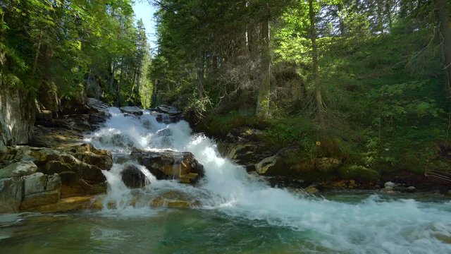4k nature video waterfall and river over wet stones in forest loop with audio
