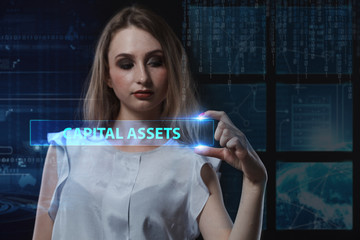The concept of business, technology, the Internet and the network. A young entrepreneur working on a virtual screen of the future and sees the inscription: Capital assets