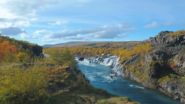moving shot of Hraunfossar waterfall in western of Iceland in autumn sunny day