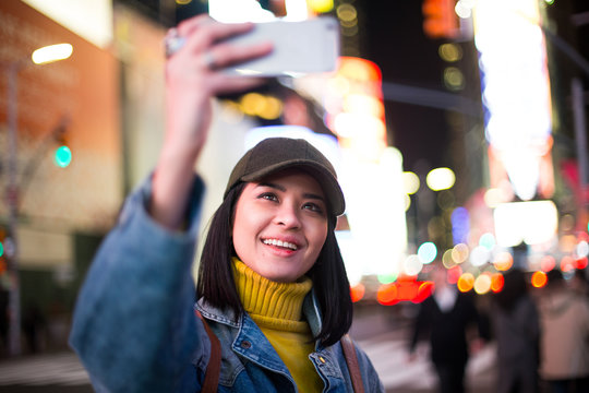 Female traveller taking selfie in Times Square