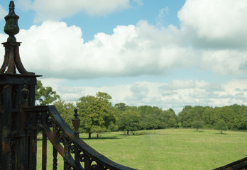 An English country estate through old wrought iron gates © Michael Pop