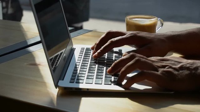 Critic uses laptop for work.