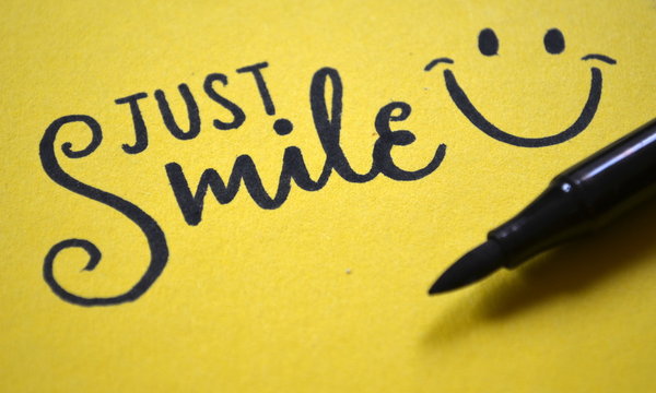 JUST SMILE hand lettered on yellow background