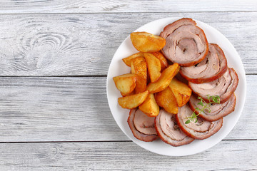turkey roulade with fried potato wedges