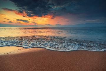Fototapeta na wymiar Beautiful sunrise over the sea water and waves