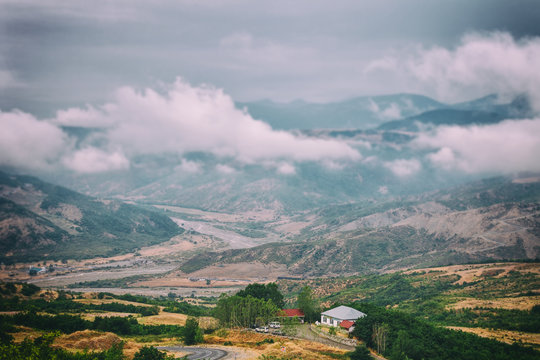 View of mountains Babadag in the clouds and a river Girdimanchay Lahij yolu from the side in Lahic village, Azerbaijan