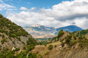 View of mountains Babadag and a muddy road along the river Girdimanchay Lahij yolu from the side in Lahic village, Azerbaijan