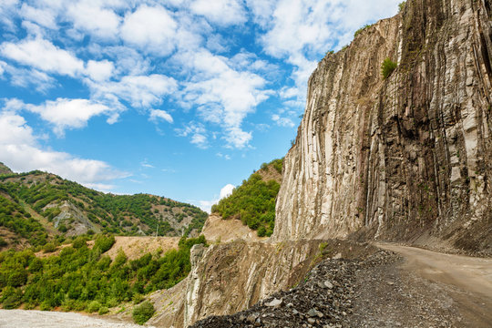 View of mountains Babadag and a muddy road along the river Girdimanchay Lahij yolu from the side in Lahic village, Azerbaijan