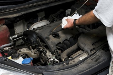 The mechanic fixes the vehicle's engine