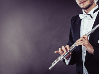 Elegantly dressed musician holding flute