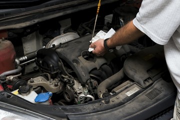 The mechanic fixes the vehicle's engine