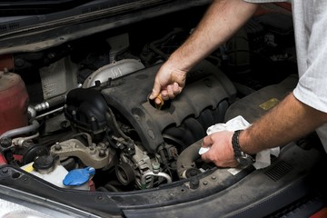 The mechanic fixes the vehicle's engine