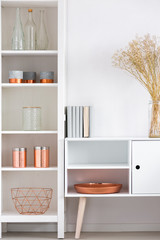 Fototapeta na wymiar White cupboard with copper plate