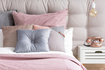 Bed with pastel color pillows