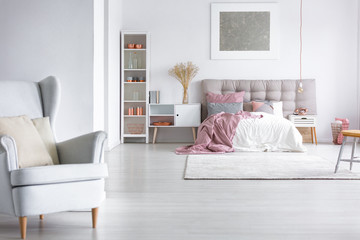 Grey armchair in cozy bedroom
