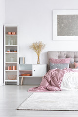 Bed with pastel pink quilt