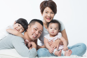 Young happy Asian family with kids