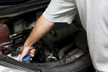 The mechanic fixes the vehicle's engine