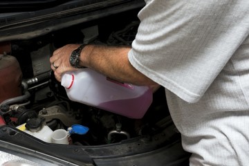 The mechanic fixes the vehicle's engine