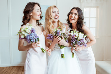 laughing bride with bridesmaids - obrazy, fototapety, plakaty