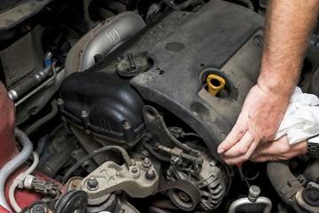 The mechanic fixes the vehicle's engine