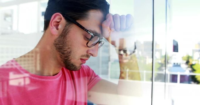 Frustrated executive heating a window glass out of rage 
