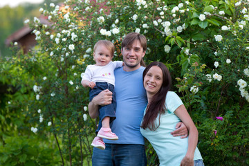 Family with baby girl walking outdoors