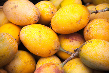 Yellow passion fruits lay on the counter
