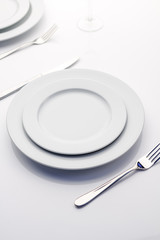Empty plates on white table with copy space for your project.