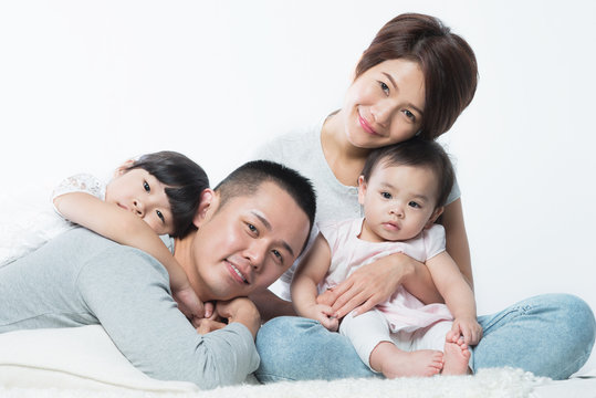 Young happy Asian family with kids
