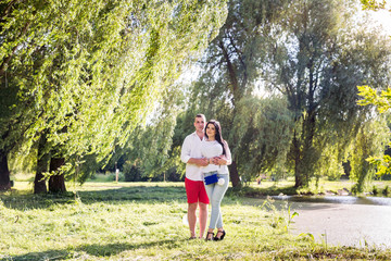 Young couple walking in summer park