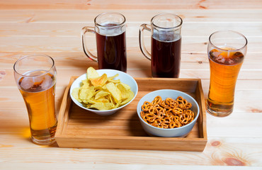 Beer and beer snacks on wooden table. Selective focus