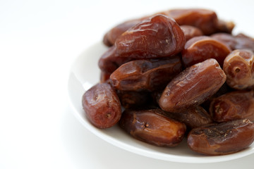 Bowl of dried dates isolated on white backgroun