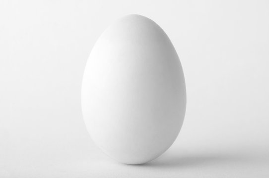 Single white egg isolated on white