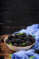 Fototapeta na wymiar Summer berry on table. Healthy lifestyle concept, blackberries in bowl.