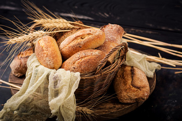 Assortment of baked bread and bun on a wooden background