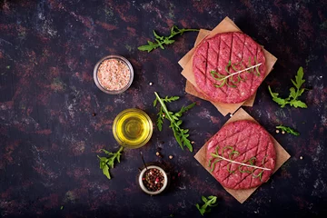 Papier Peint Lavable Steakhouse Fresh raw homemade minced beef steak burger with spices on black background