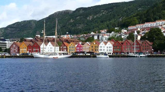 Sailboat in front of Bryggen (the dock) Tyskebryggen buildings at the Vagen harbour in Bergen, Norway