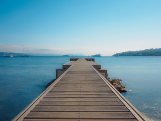 Obraz premium A photograph taken with a long exposure of an empty quay near the Mediterranean Sea.