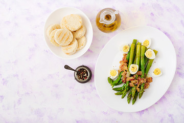 Young shoots of asparagus with ham and quail eggs