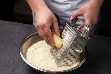 the cook is rubbing potatoes on a grater