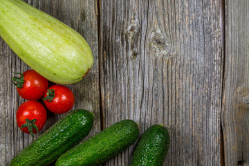 Summer fresh organic vegetables on old wooden background
