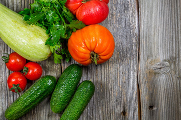 Mixed vegetables on wooden table top view. Organic food from local farm