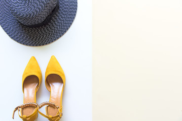Fashion woman accessories set. Trendy fashion yellow shoes heels, stylish big hat. Colorfull background.  Lifestyle Concept.