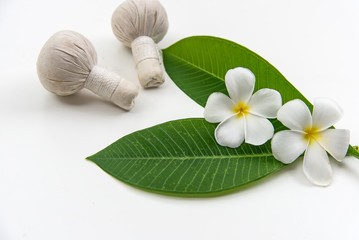 Fototapeta na wymiar Thai Spa massage compress balls, herbal ball and treatment spa, relax and healthy care with white flower, Thailand. Healthy Concept. select focus